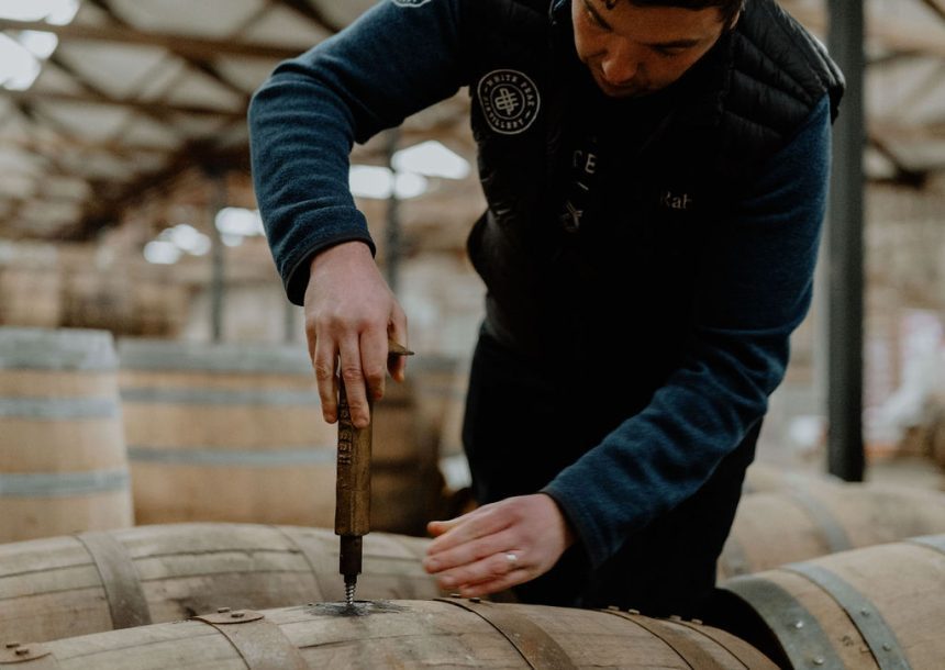 Distiller sampling whisky cask