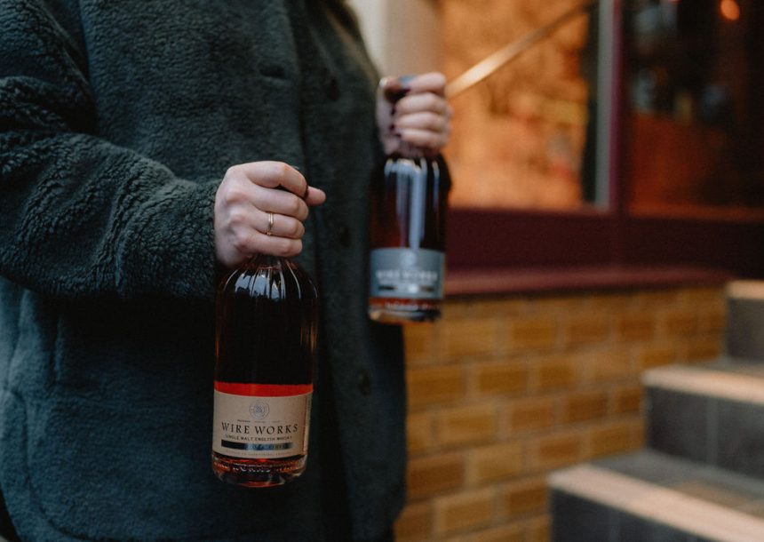 woman carrying Wire Works Whisky
